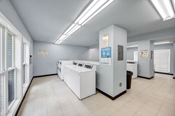 A laundry room with washers and dryers.
